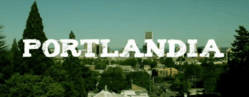 An image of a city skyline in daytime. White text reads "Portlandia".