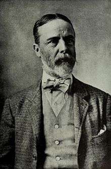 Black and white portrait of a man with full beard, about 56, dressed in a three-piece suit with a bowtie.