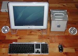 An Apple Studio Display connected to a Power Mac G4 Cube