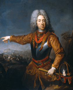 A painting of a 17th-century man wearing an armored breast plate pointing at a battlefield behind him. A sword can be seen at his hip and a helmet lies next to him.