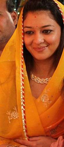 Priyadarshini Raje Scindia wearing a golden-yellow sari.
