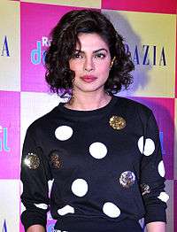 Priyanka Chopra, with short, curly hair, in a polka-dot top