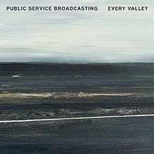 A mostly charcoal grey, lightly blue painting of coal mountains backdropped against a overcast sky. The words "Public Service Broadcasting" and "Every Valley" are written in bold black font on the top left and top right corners of the image, respectively. It is titled "Viaduct', and was painted by Hannah Benkwitz.
