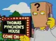 Cartoon frame showing a man with a paper bag over his head talking into a mobile phone. The bag has a large question mark printed on it and the man stands in front of a large illuminated sign in block letters which says 'THOMAS PYNCHON'S HOUSE&nbsp;– COME ON IN'