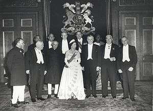 A formal group of Elizabeth in tiara and evening dress with eleven prime ministers in evening dress or national costume.