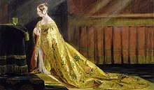 Demure young Victoria kneeling before a gold communion cup and wearing a gold robe decorated with roses, thistles and shamrocks