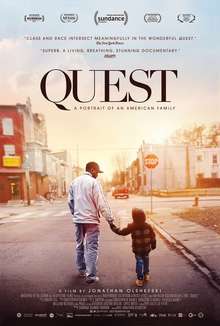 A man and a boy holding hands, stand on a street in front of a stop sign. The title "Quest" appears above them with the tagline "A Portrait of an American Family"