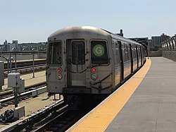 View of the end of a southbound "G" train at the elevated Smith-Ninth Streets station. The train consists of cars with the contract name R68.