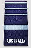 A black shoulder board with the word "AUSTRALIA" across the bottom. Above the word is a thick, blue horizontal stripe, with three thinner blue horizontal stripes above that.