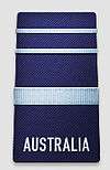 A black shoulder board with the word "AUSTRALIA" across the bottom. Above the word is a thick, blue horizontal stripe, with two thinner blue horizontal stripes above that.