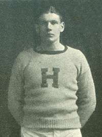 The article subject posing against a dark background while wearing his Hill School sports uniform with a prominent letter "H" on the chest