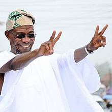 Governor of the State of Osun, Ogbeni Rauf Aregbesola raises both hands in victory sign during a project inspection tour across the state in September, 2017