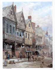 A street in the 19th century with buildings on the left, the first of which is timber-framed and highly decorated. In front of the house is a horse and cart