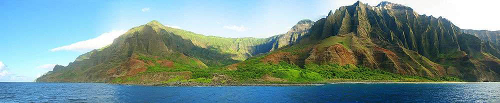 view of the Nā Pali coastline from the ocean. It is part of the Nā Pali Coast State Park which encompasses 6,175 acres (20&nbsp;km2) of land and is located on the northwest side of Kauaʻii.