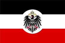 Tricolour flag of the German Empire with horizontal bands of black, white and red. Superimposed over it is the grand coat of arms of the Empire: an Imperial German black eagle with the crown of the Holy Roman Empire and the black-and-white chequerboard Hohenzollern escutcheon, surrounded by the chain and cross of the Prussian Order of the Black Eagle.