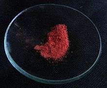 Red powder on a watch glass