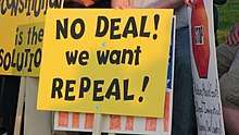 A black-on-yellow sign saying "No deal! We want repeal!"