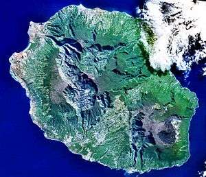 An overhead view of an island filled with high-altitude peaks.