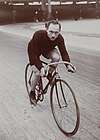 Scheuermann posed on bicycle from between 1905-1906.