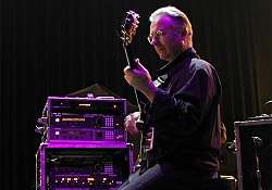 Robert&nbsp;Fripp ergonomically plays electric&nbsp;guitar while sitting in a posture developed through years of application of the Alexander Technique.