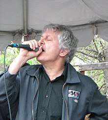 Pollard singing into a microphone