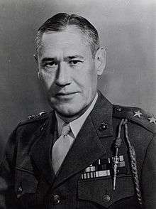 A black and white image of Keller Rockey, a white male in his Marine Corps dress uniform