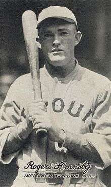 Rogers Hornsby in a St. Louis Browns uniform, a bat held over his right shoulder