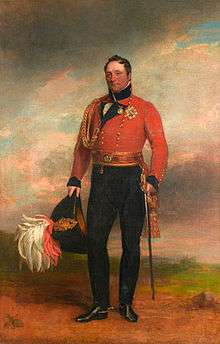 Painting shows a man in a red military coat with black trousers. He holds a bicorne hat with an elaborate plume.