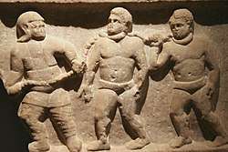 Relief wall sculpture of three slaves collared together