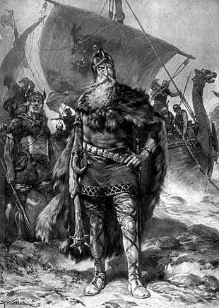 A bearded older man, dressed for battle