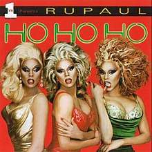 An image of three RuPauls wearing three different colored dress (green, red, and gold). They are standing against a red background with the album’s title above them.
