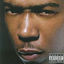 The cover has the artist giving a mean and threatening look behind a black background. On the bottom right corner of the cover is the Parental Advisory label.