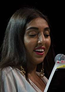 Rupi Kaur reading from her book milk and honey in Vancouver in 2017