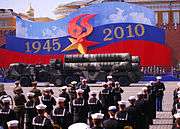 Members of Commander, U.S. Naval Forces Europe Band prepare to perform during the 2010 Victory Day Parade. Two S-400 SAMS are driving in front of the band.