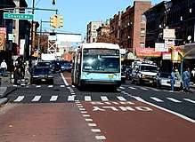 Offset, red-painted bus lane on Nostrand Avenue in Brooklyn