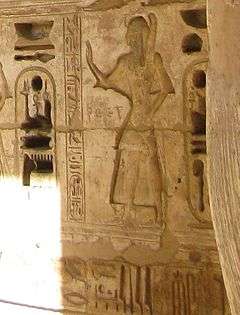 Relief of a man standing, surrounded by hieroglyphs.