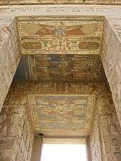 Stone doorway whose jambs and lintels are covered with images and hieroglyphs in relief. The reliefs are painted various colors.
