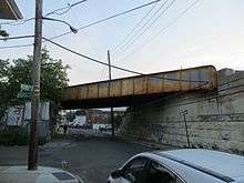 Rusting trestle over a one-way street