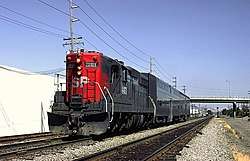 West of Santa Clara, a Southern Pacific EMD SD9 leads a two-car train before the Caltrain takeover