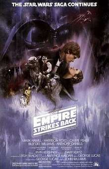 . This poster shows a montage of scenes from the movie. Dominating the background is the dark visage of Darth Vader; in the foreground, Luke Skywalker sits astride a tauntaun; Han Solo and Princess Leia gaze at each other while in a romantic embrace; Chewbacca, R 2-D 2, and C-3PO round out the montage.