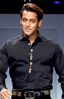 A smiling Salman Khan in a black shirt