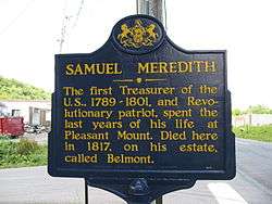 Blue sign reads "SAMUEL MEREDITH: The first Treasurer of the U.S., 1789-1801, and Revolutionary patriot, spent the last years of his life at Pleasant Mount. Died here in 1817, on his estate, called Belmont."