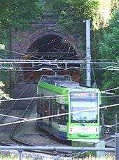 A photo of the accident site in 2010, showing a tram exiting the tunnel and entering the curve