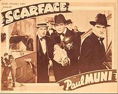 Tony holds a covered Tommy gun with other characters around him in a promotional card for the film stating "Scarface" with Paul Muni