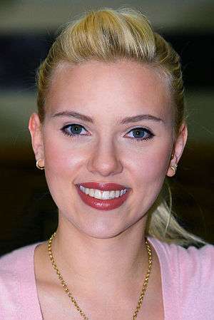 Scarlett Johansson, wearing a pink dress, poses for the camera.
