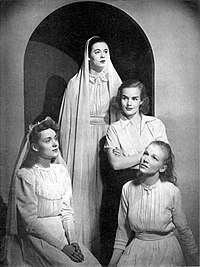 Three woman posed in shawls
