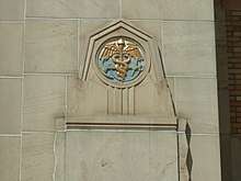 An anchor and caduceus  on the exterior of a building