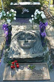 Elaborate grave marker with flowers