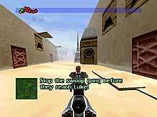 A man rides a hover bike through the streets of a fictional desert city.