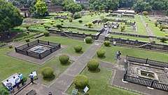 The Gardens of Shaniwar Wada are seen. The foundations of many structures as well as fountains are also present.